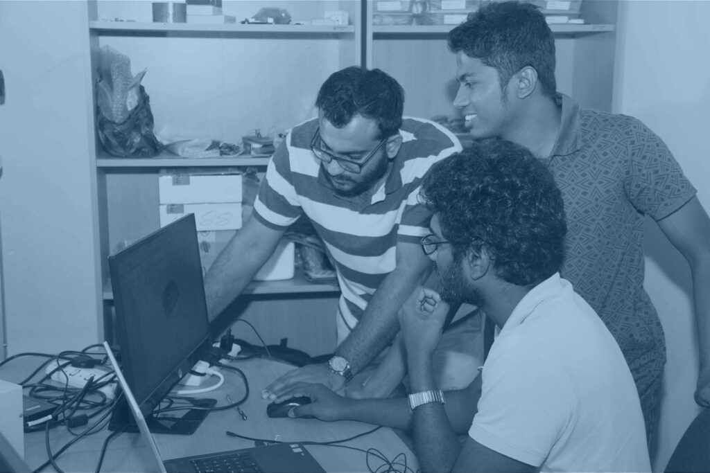 Three Research and Development Engineers looking at a product design on a monitor